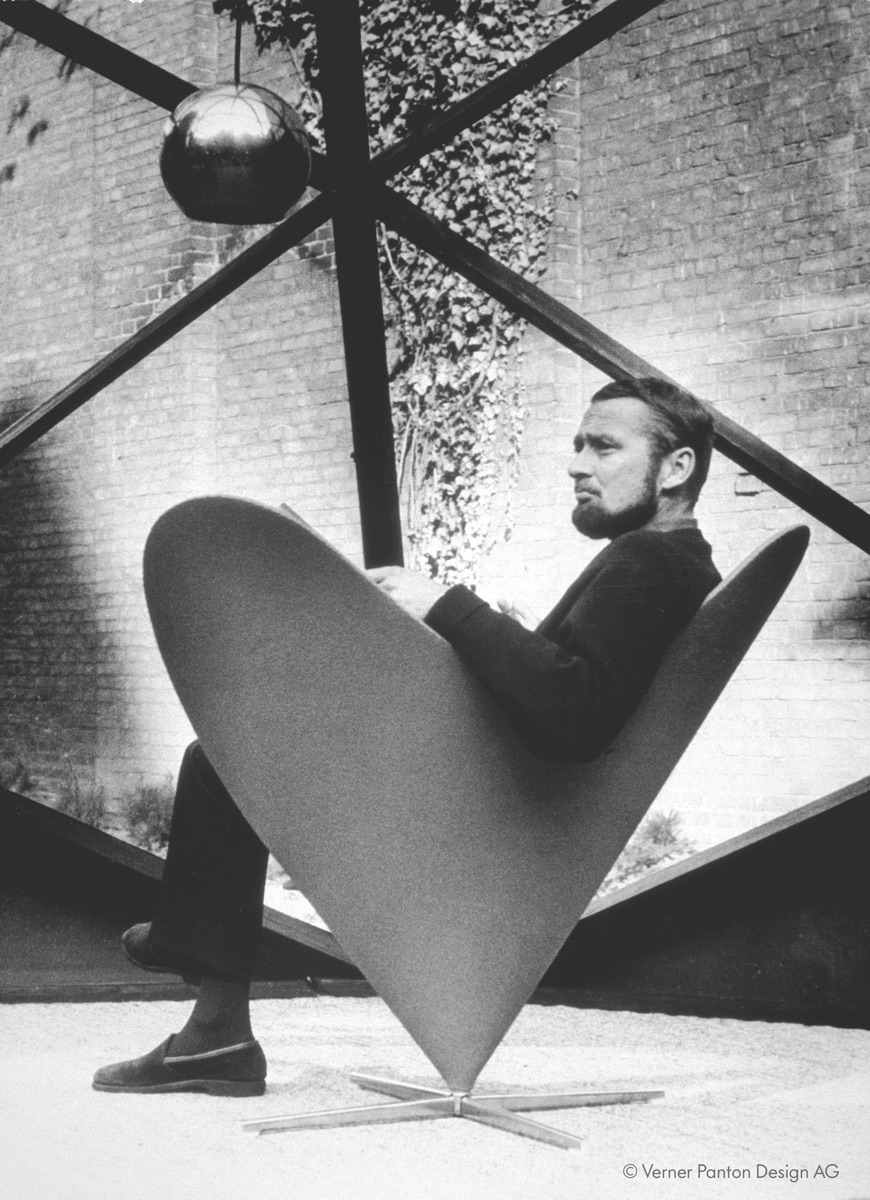 Verner Panton reading in a Cone Chair, the seat he designed for the Kom-igen restaurant. Photo © Verner Panton Design AG